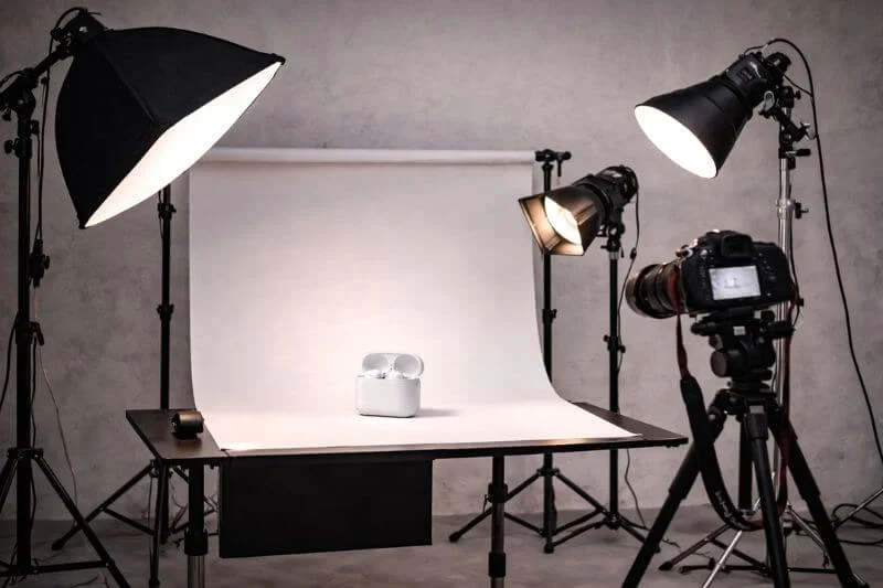 commercial photography equipment including camera tripod and studio lights