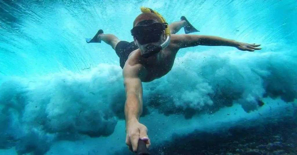 practicing underwater camera handling on land before diving