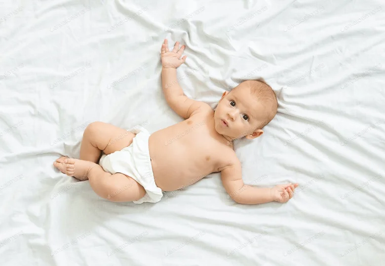 newborn baby in bed