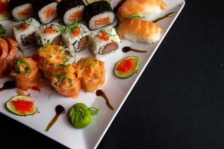 white ceramic plate filled with sushi, food photography guide